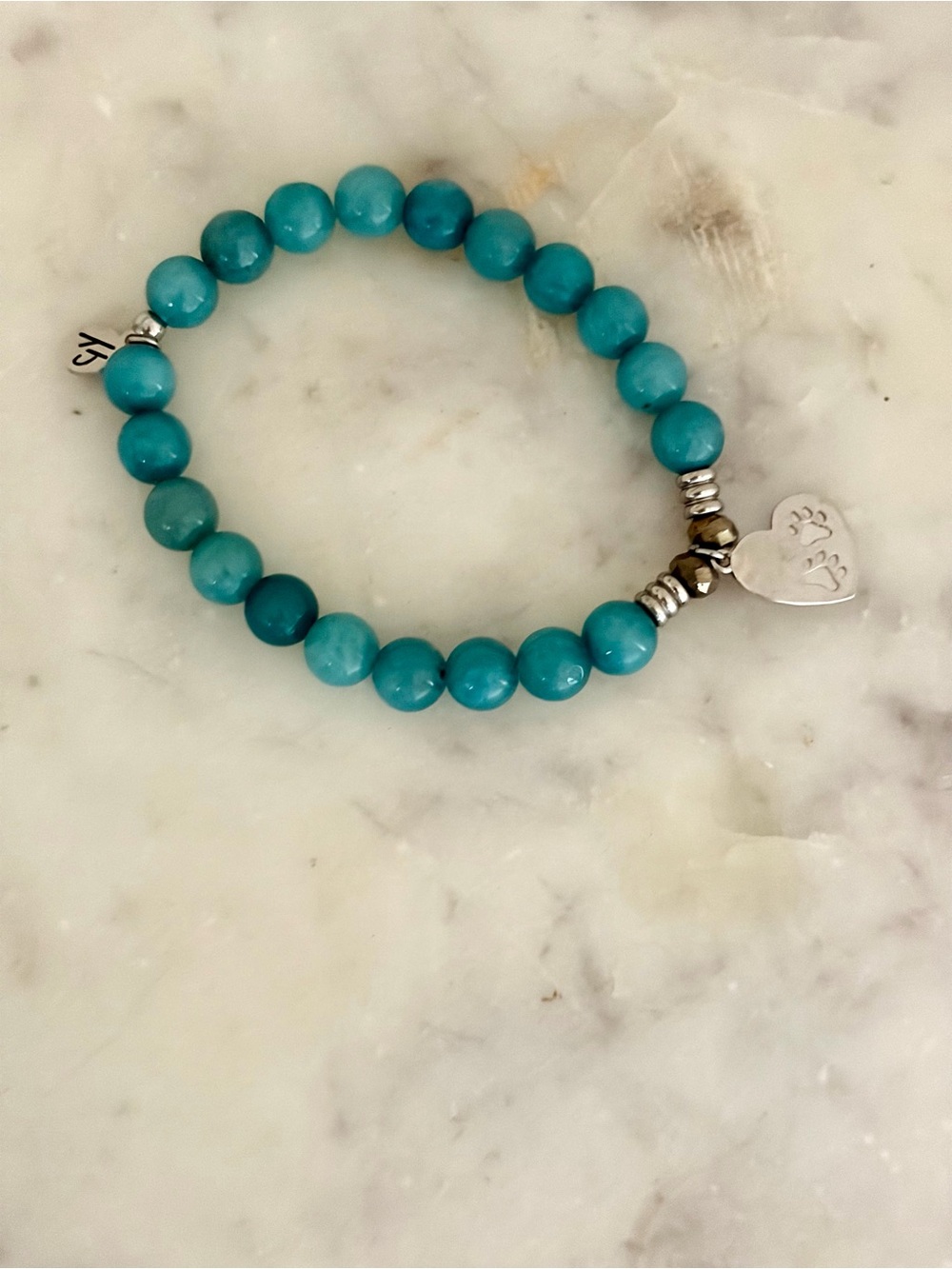Hand crafted semi precious stones with a sterling silver paw/heart charm